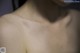 A close up of a person's back with water droplets on it.
