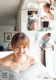 A woman sitting on top of a table next to a window.